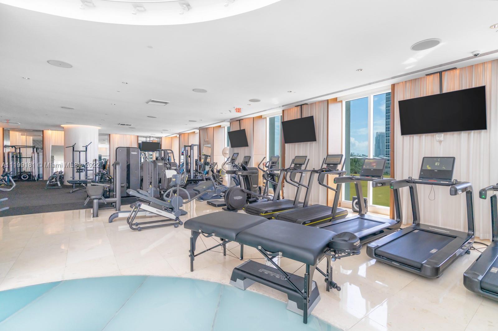 450 Alton Road, Unit 3303 Miami Beach, FL 33139 - Photo 23 of 35 a living room with furniture a flat screen tv and kitchen view