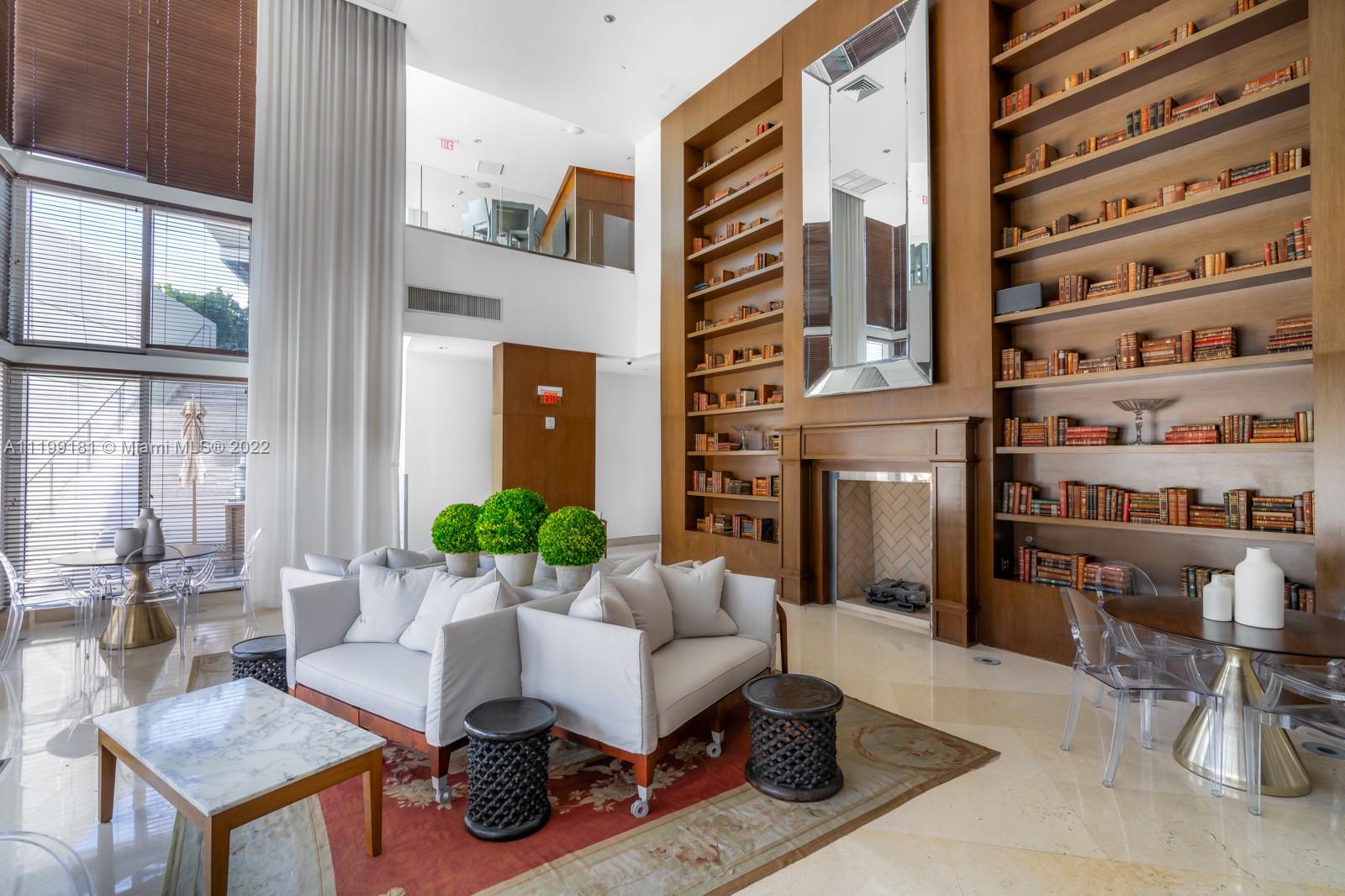 450 Alton Road, Unit 3303 Miami Beach, FL 33139 - Photo 25 of 35 a living room with furniture a chandelier and a potted plant