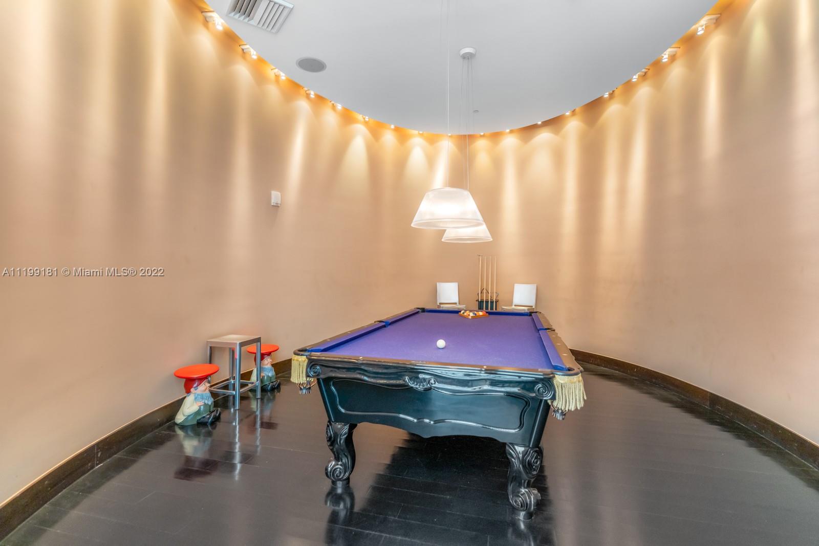 450 Alton Road, Unit 3303 Miami Beach, FL 33139 - Photo 26 of 35 a view of a room with furniture and a chandelier