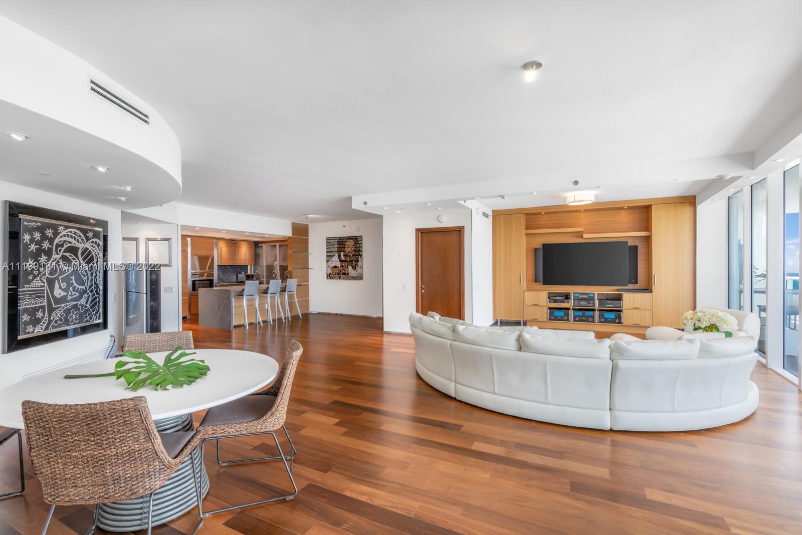 450 Alton Road, Unit 3303 Miami Beach, FL 33139 - Photo 4 of 35 a living room with furniture and a flat screen tv