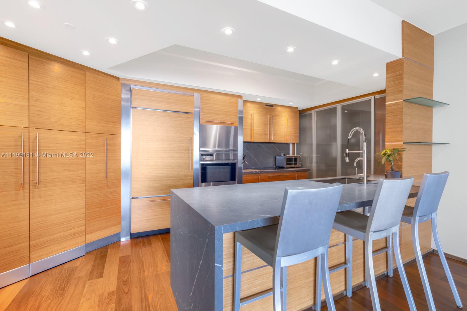 450 Alton Road, Unit 3303 Miami Beach, FL 33139 - Photo 5 of 35 a view of a dining room with furniture and wooden floor