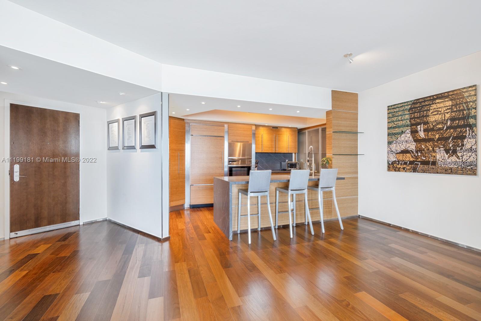 450 Alton Road, Unit 3303 Miami Beach, FL 33139 - Photo 7 of 35 a view of a livingroom with furniture and wooden floor
