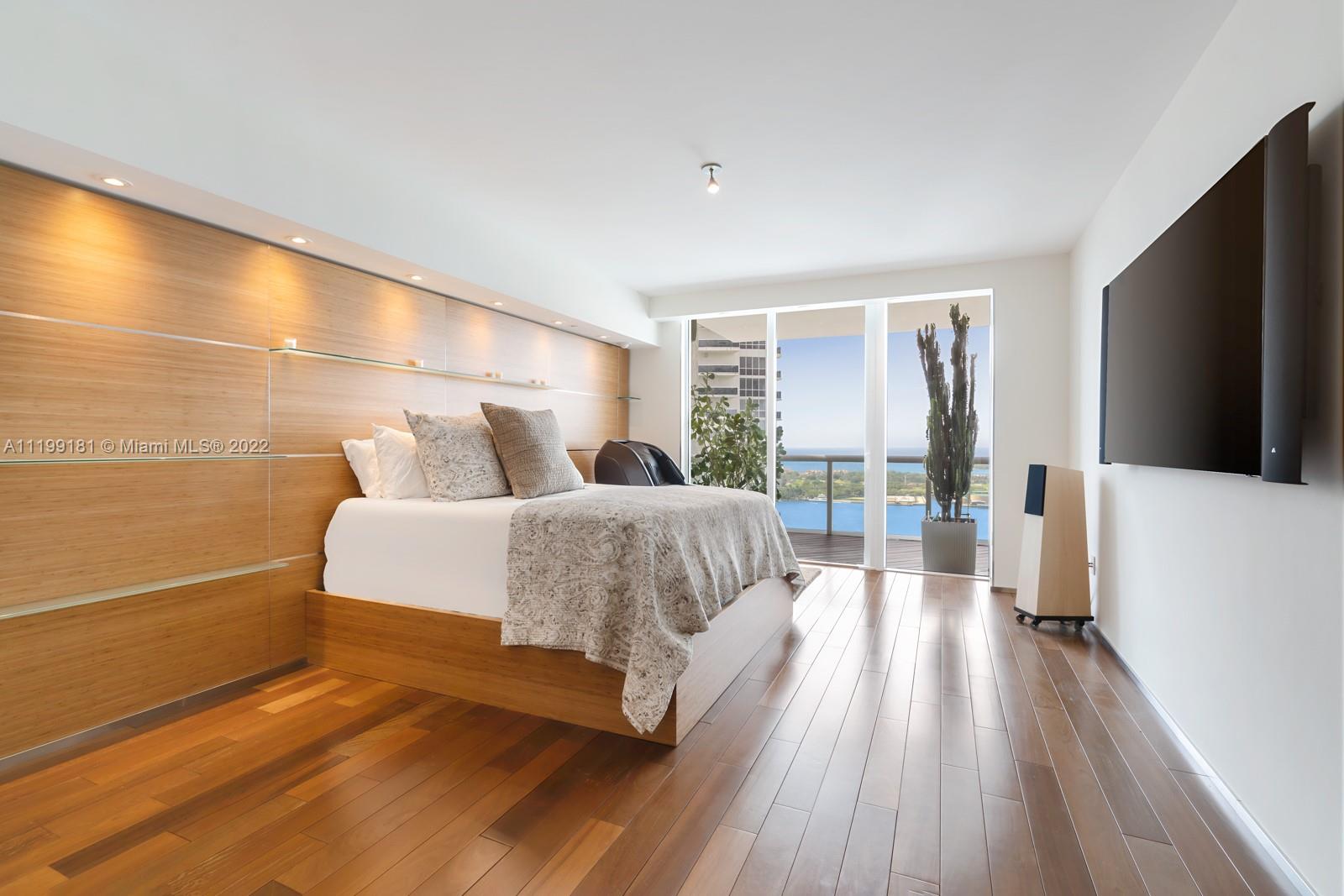 450 Alton Road, Unit 3303 Miami Beach, FL 33139 - Photo 9 of 35 a bedroom with a bed and a flat tv screen on dresser