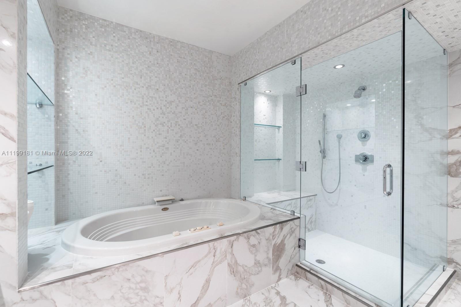 450 Alton Road, Unit 3303 Miami Beach, FL 33139 - Photo 10 of 35 a bathroom with a granite countertop sink mirror and shower