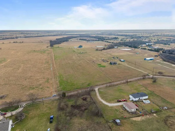 an aerial view of a residential houses with outdoor space