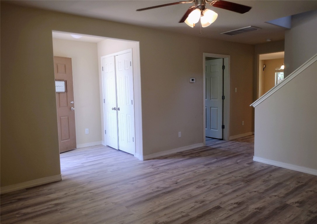 126 Preston Trail San Marcos, TX 78666 - Photo 4 of 24 an empty room with wooden floor and a ceiling fan