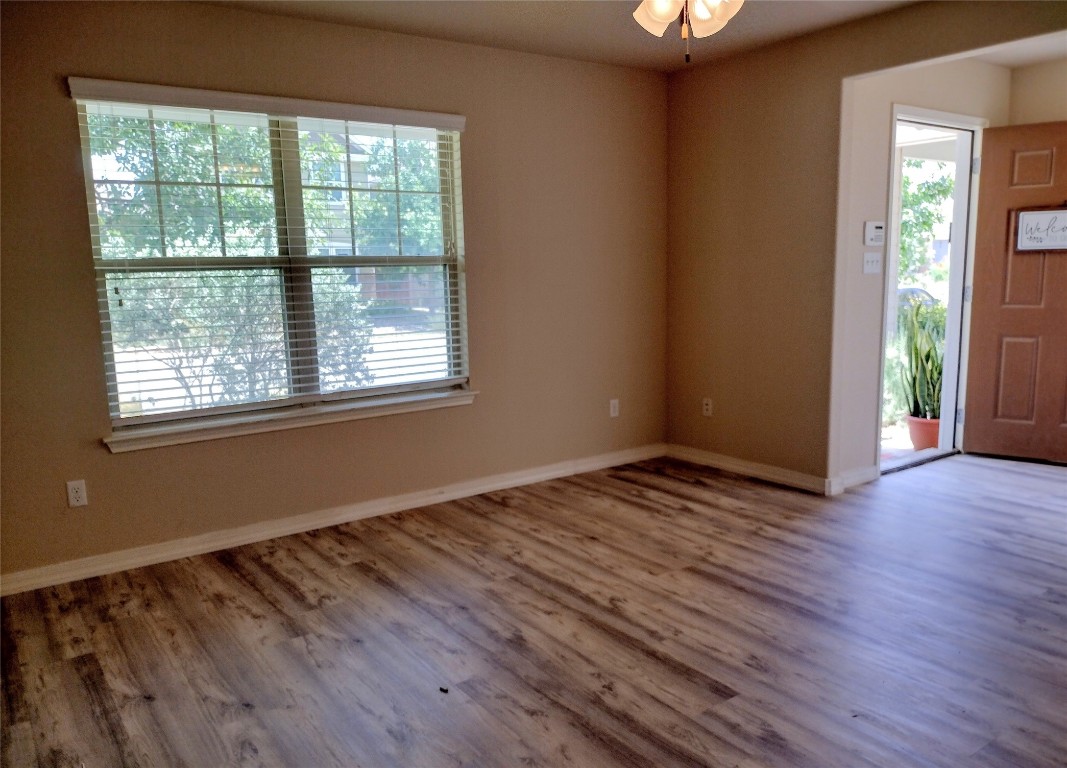 126 Preston Trail San Marcos, TX 78666 - Photo 5 of 24 a view of an empty room with wooden floor and a window