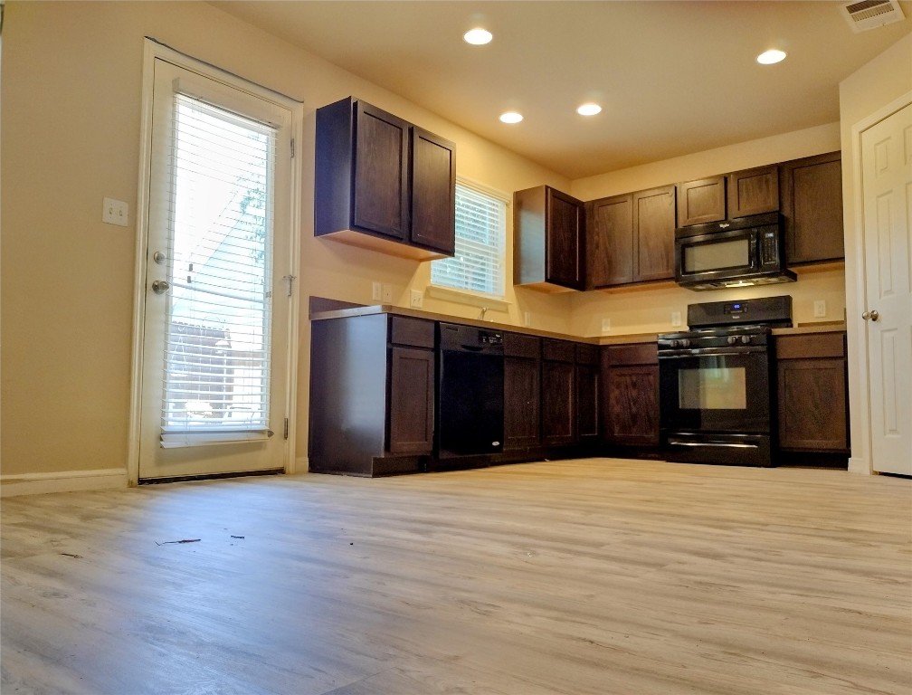 126 Preston Trail San Marcos, TX 78666 - Photo 9 of 24 a view of kitchen with stainless steel appliances granite countertop a stove and a wooden cabinets