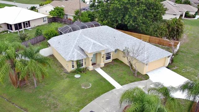 a view of a house with a yard and garage