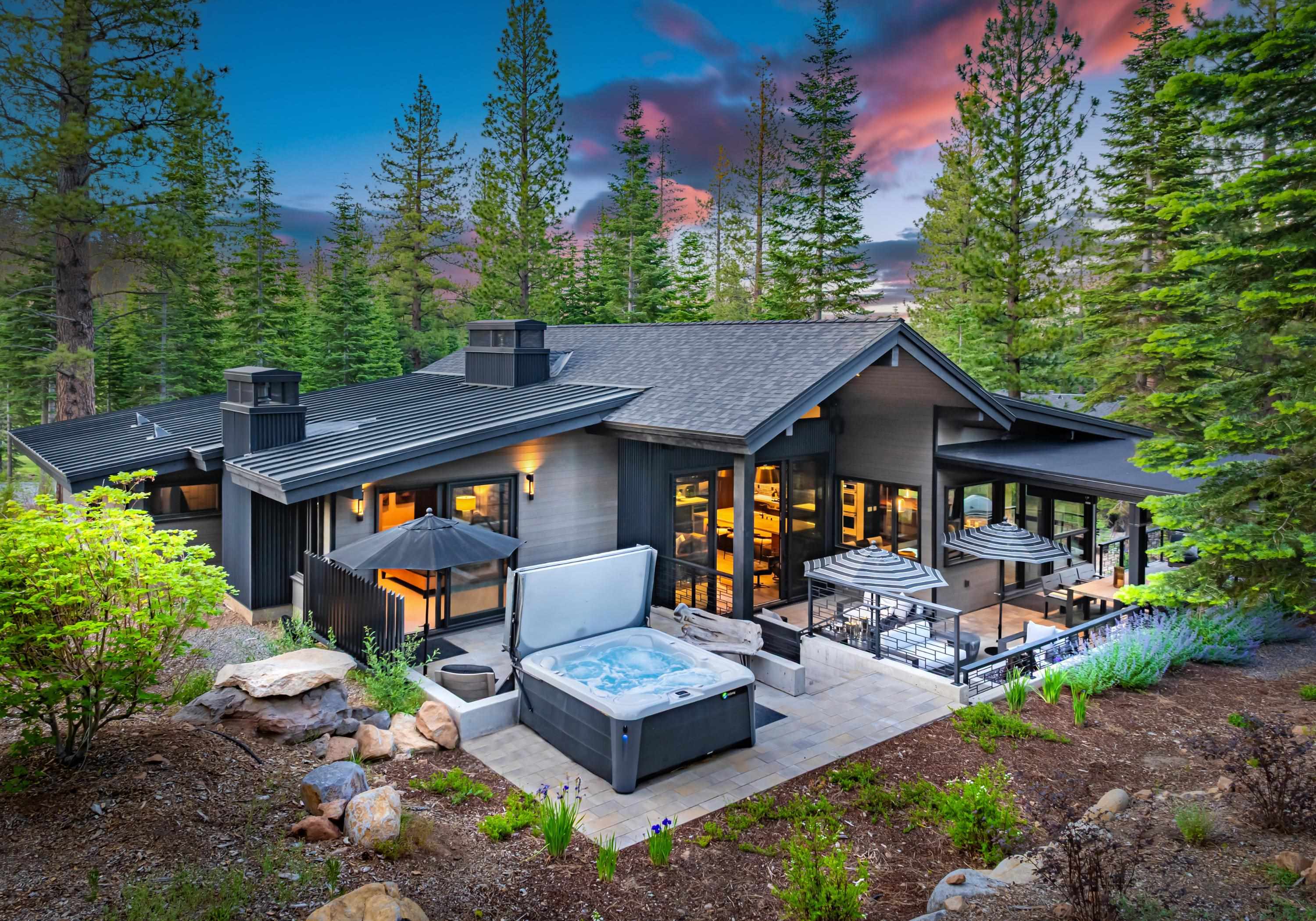 a front view of a house with garden and patio