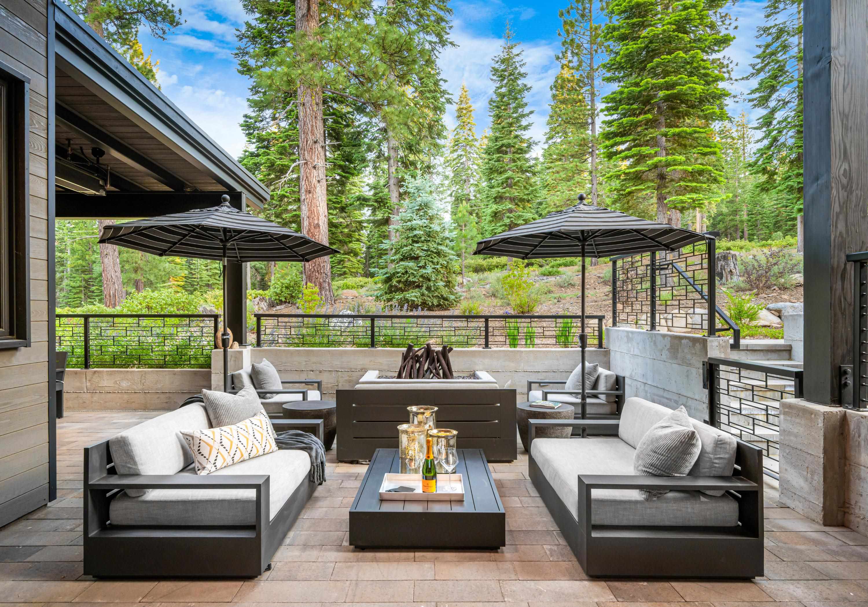 10625 Carson Range Road Truckee, CA 96161 - Photo 4 of 8 a view of patio with couches table and chairs under an umbrella with a barbeque