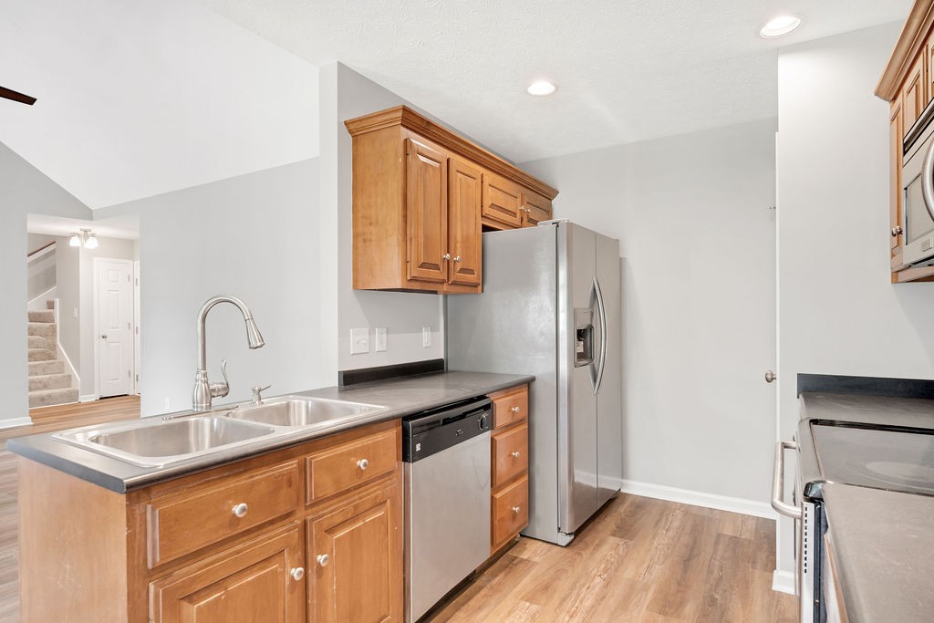 165 Foxrun Springfield, TN 37172 - Photo 20 of 62 a kitchen with stainless steel appliances granite countertop a refrigerator and a sink