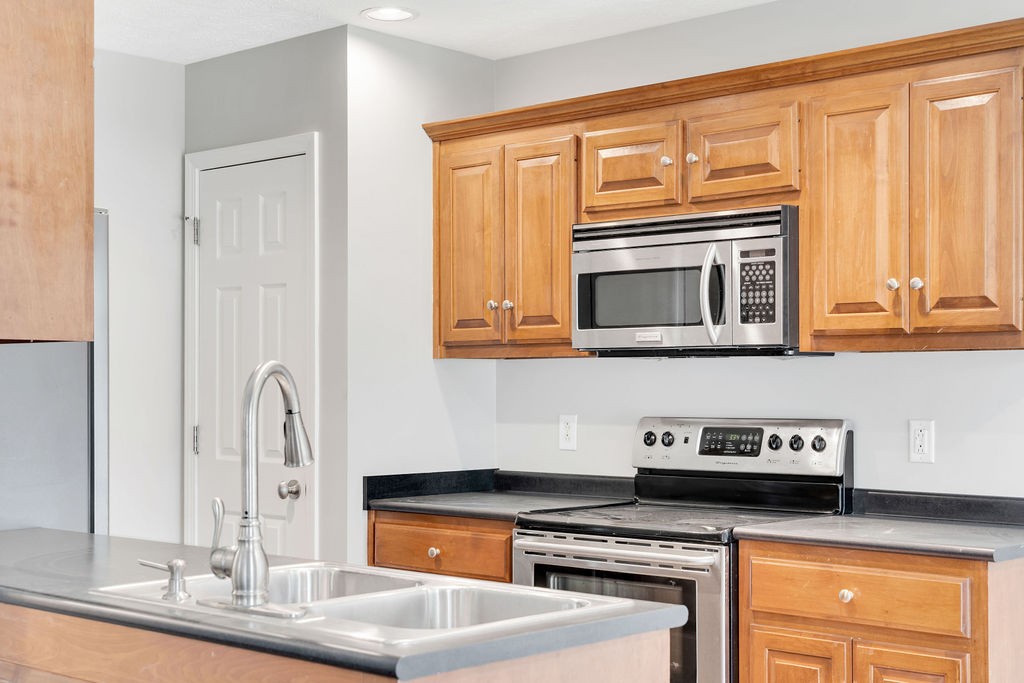 165 Foxrun Springfield, TN 37172 - Photo 23 of 62 a kitchen with stainless steel appliances granite countertop a stove and a microwave