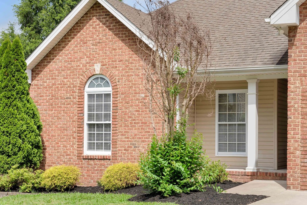 165 Foxrun Springfield, TN 37172 - Photo 5 of 62 a view of a brick house with large windows and a yard