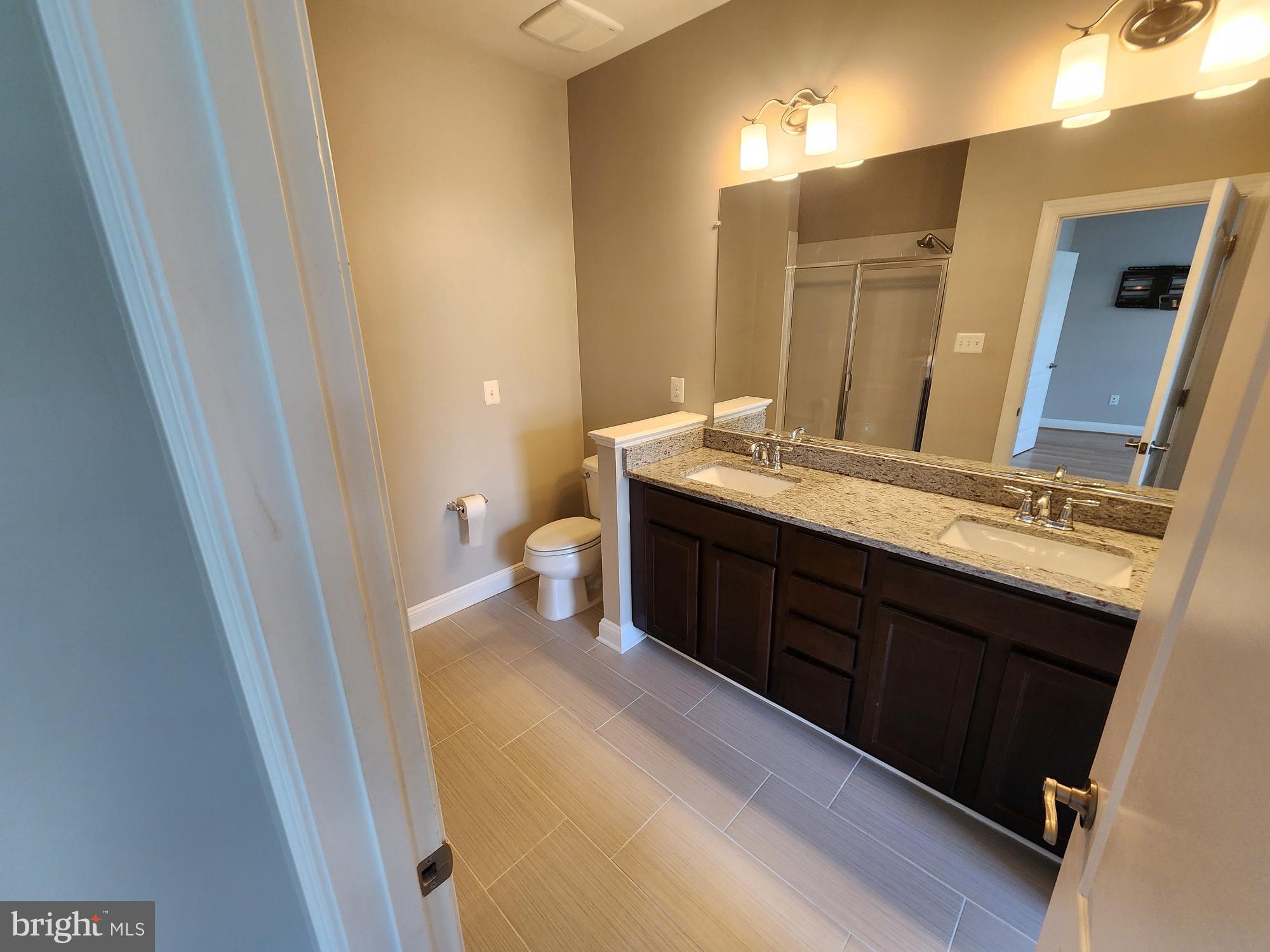 2 Maxwell Square Frederick, MD 21701 - Photo 8 of 16 a spacious bathroom with a granite countertop sink and a mirror