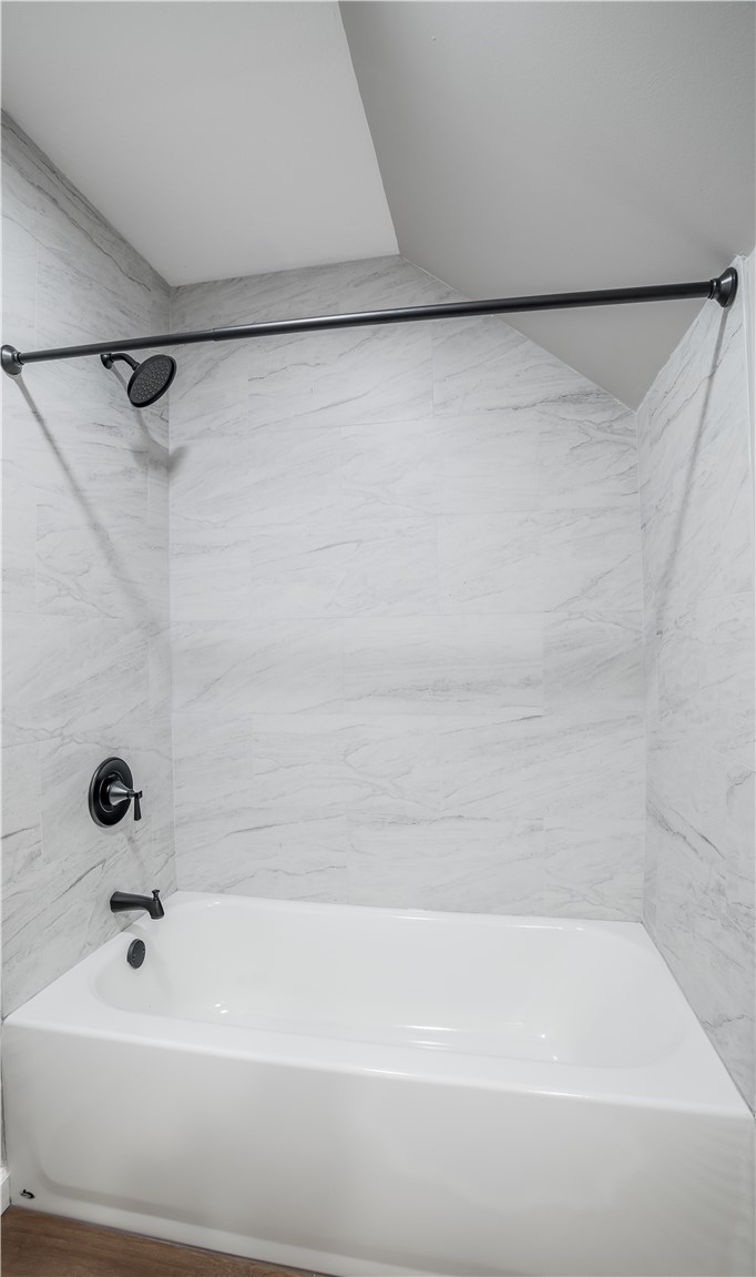 8240 Looney Road Piqua, OH 45356 - Photo 28 of 49 This bathroom features a sleek bathtub with a contemporary shower, creating a tranquil retreat.
