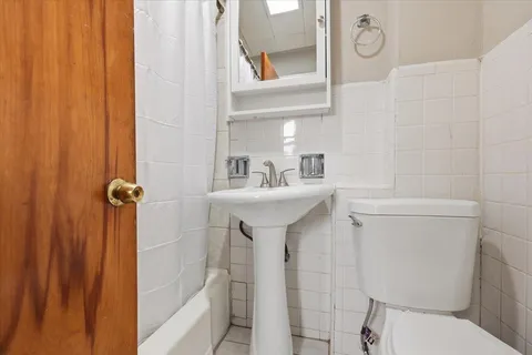 a bathroom with a sink mirror toilet and shower