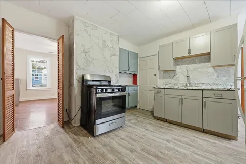 a kitchen with a stove oven and sink