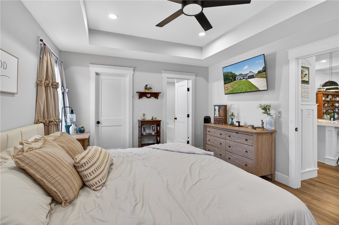 106 Bolt Road Townville, SC 29689 - Photo 12 of 33 Recessed lighting illuminates this inviting bedroom, featuring a tray ceiling and a convenient ceiling fan.