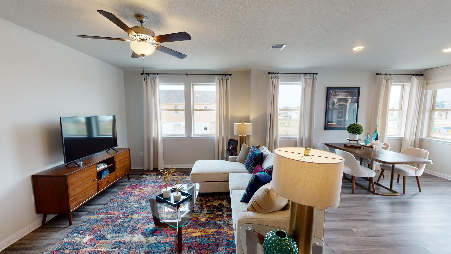 8111 Springsteen Drive Austin, TX 78744 - Photo 1 of 11 Representative Image - Living room featuring dark wood-style floors and a ceiling fan