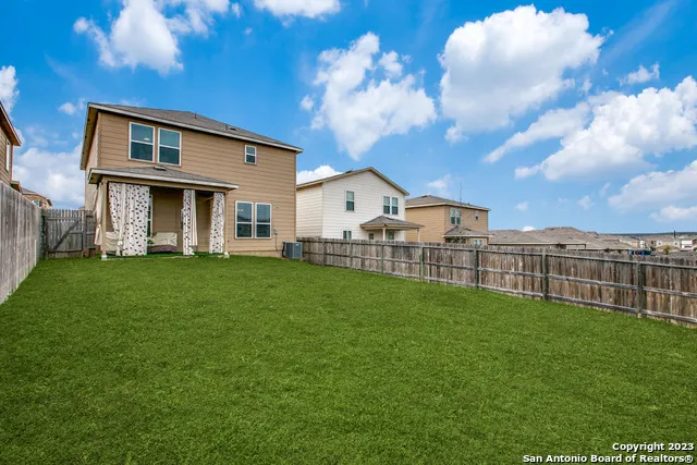 a view of a house with a back yard