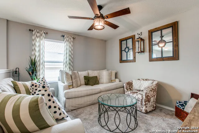 a living room with furniture and a large window