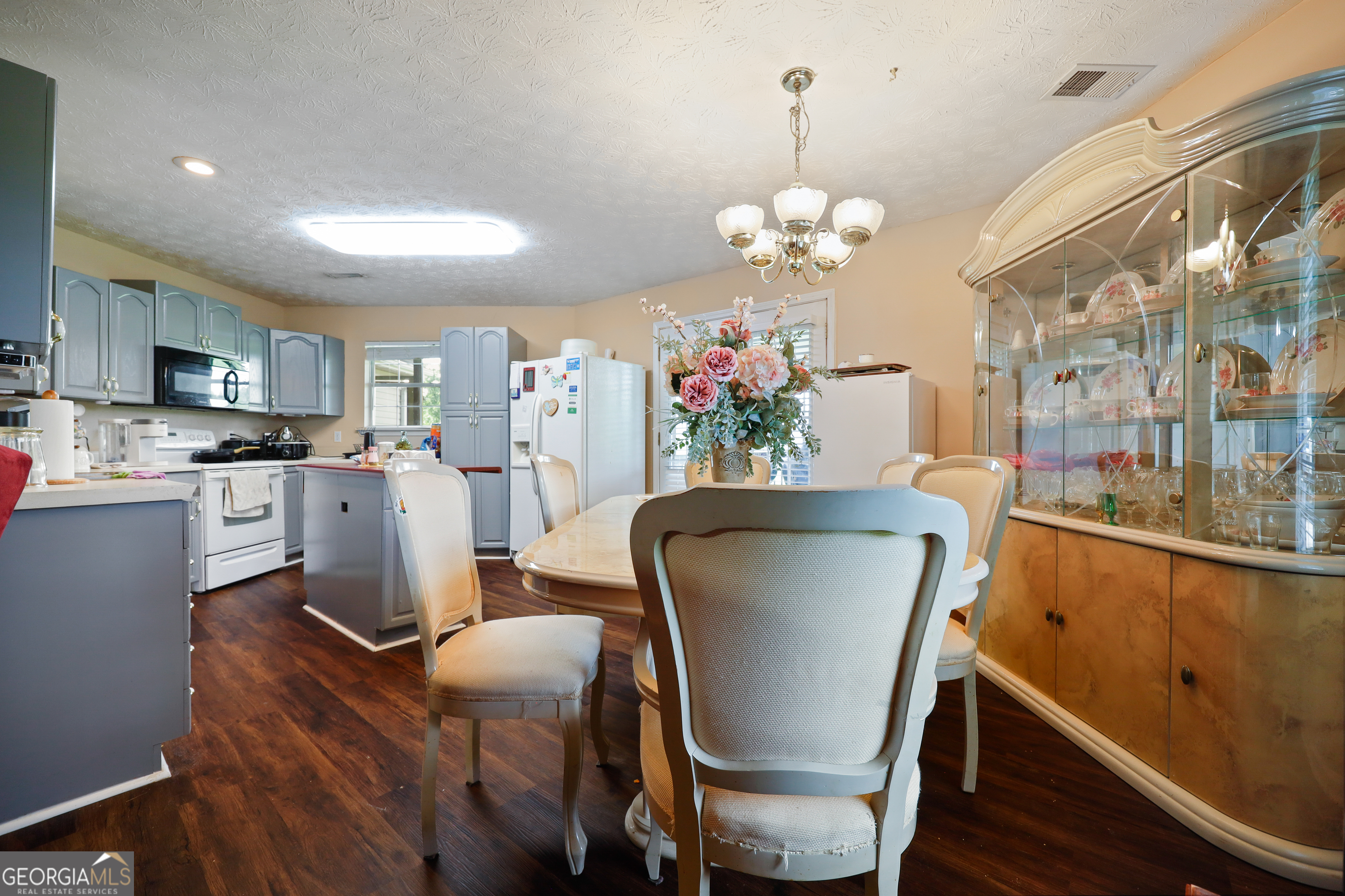 2433 Bear Creek Road Statham, GA 30666 - Photo 43 of 58 a dining room filled chandelier and wooden floor