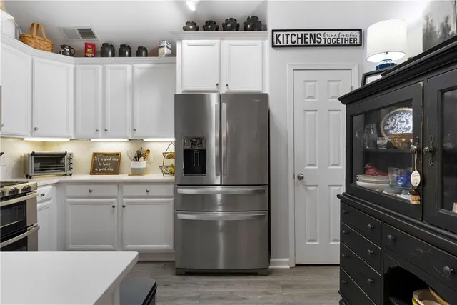 a kitchen with stainless steel appliances a refrigerator and cabinets
