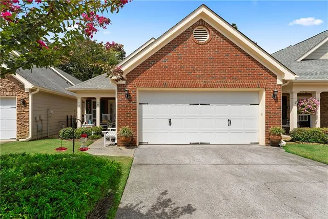 a view of a house with a yard and garden