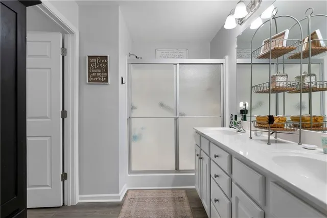 a bathroom with a sink a mirror and a shower