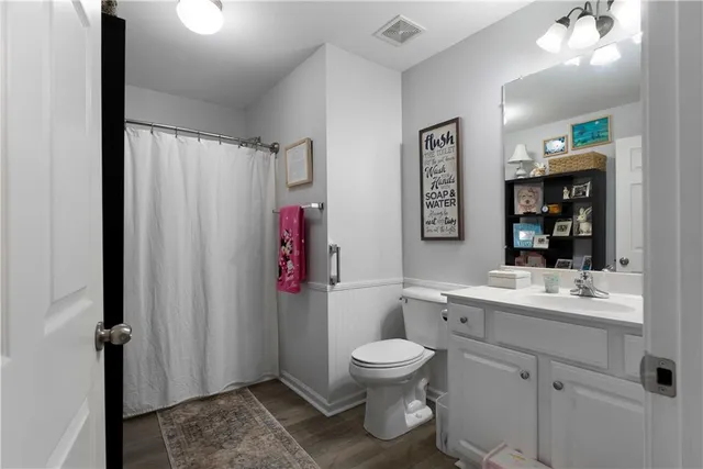 a bathroom with a toilet sink and shower