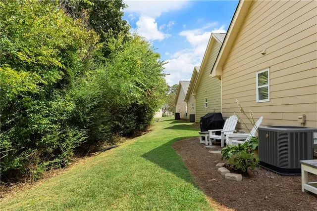 a view of backyard with seating space and trees