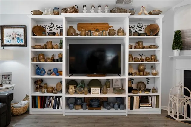 a shelf with books and knick knacks on it