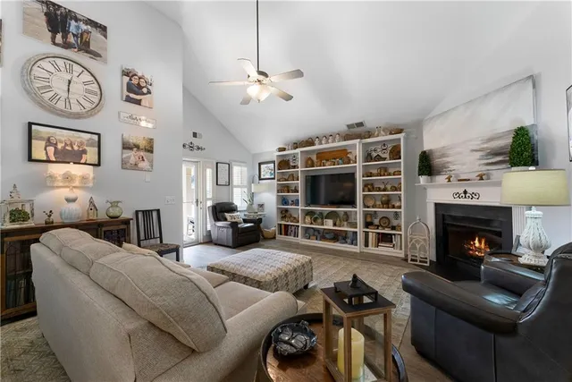 a living room with furniture a flat screen tv and a fireplace