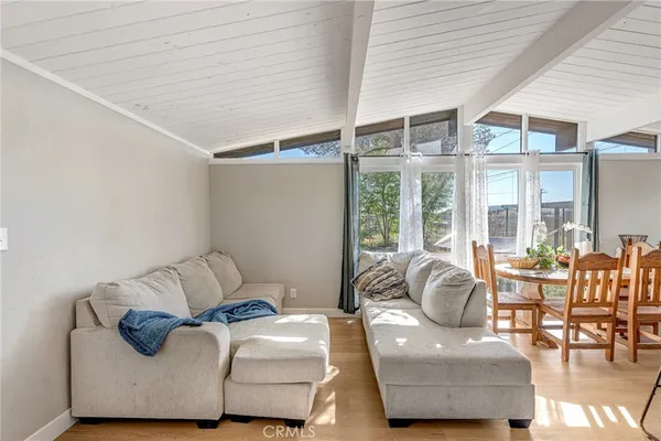 a bedroom with furniture and a large window