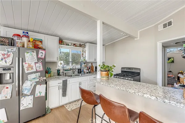a kitchen with sink and refrigerator