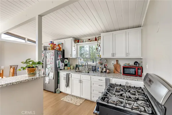 a kitchen with stainless steel appliances a sink stove and cabinets