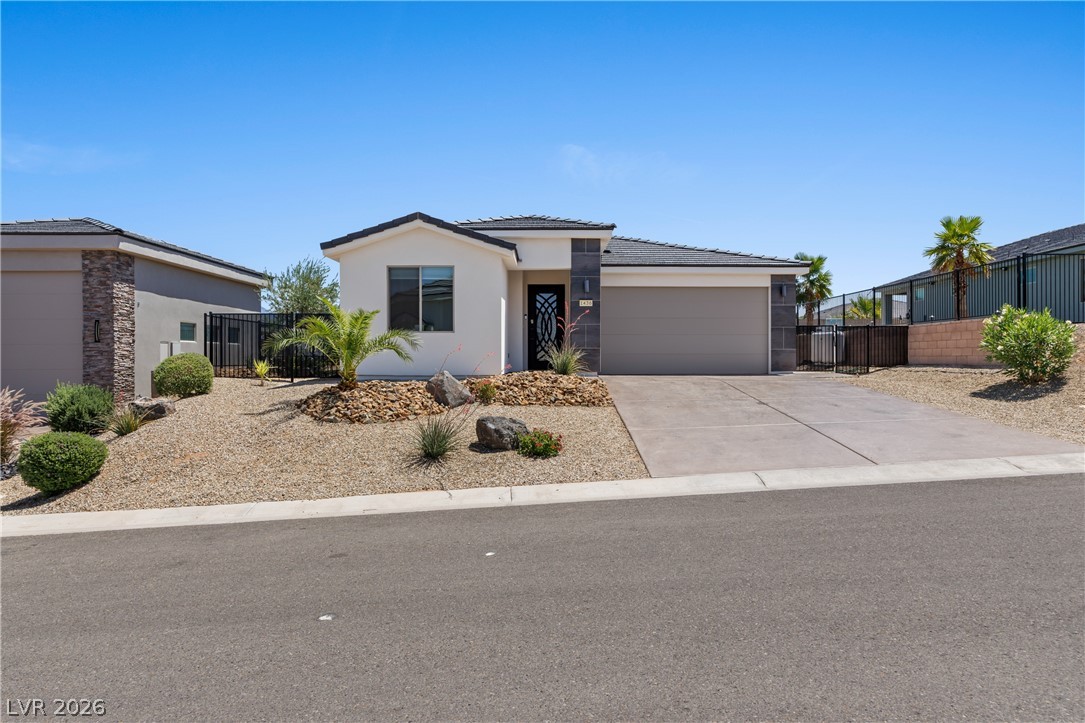 1436 Manassas Ridge Mesquite, NV 89027 - Photo 69 of 77 A well-maintained desert landscape frames this contemporary home, offering attractive curb appeal.
