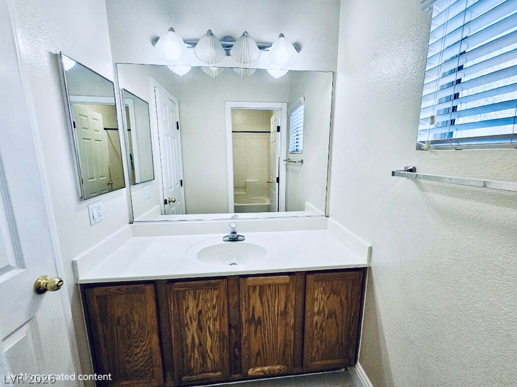 5953 Crumbling Ridge Street Henderson, NV 89011 - Photo 36 of 42 A pristine bathroom vanity, complete with a generous mirror and ample storage.