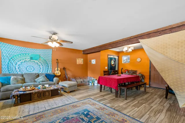 a living room with furniture a rug and a chandelier