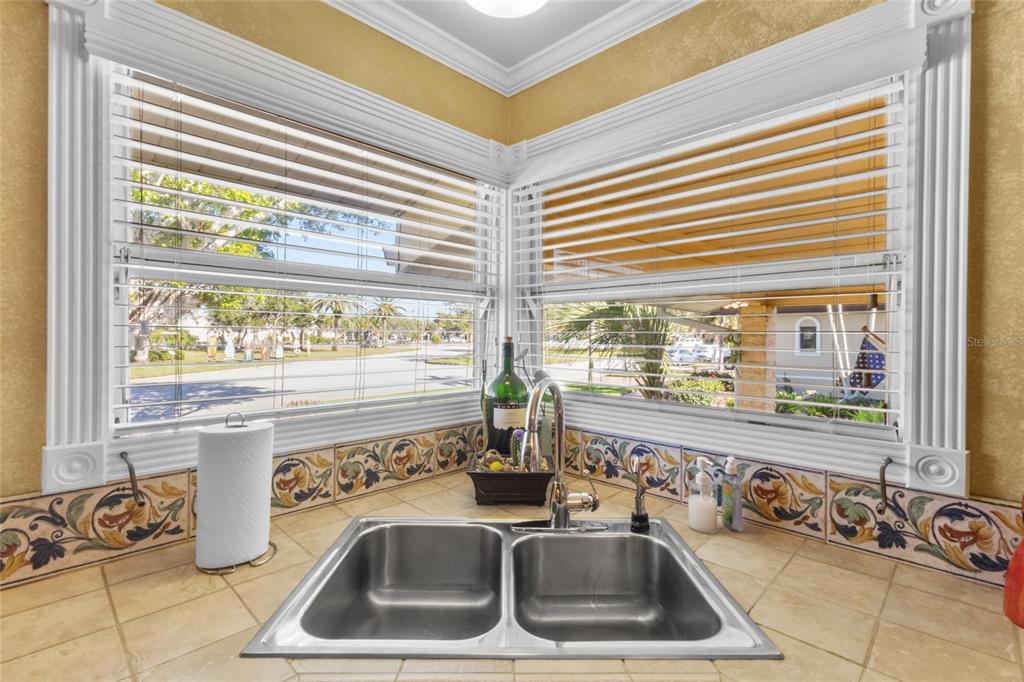 420 Pensacola Road Venice, FL 34285 - Photo 11 of 40 a kitchen with a sink and a large window