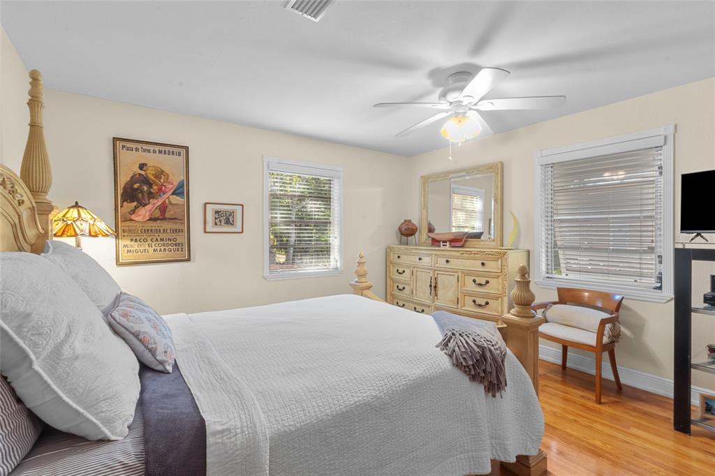 420 Pensacola Road Venice, FL 34285 - Photo 16 of 40 a bedroom with a bed a table and chair