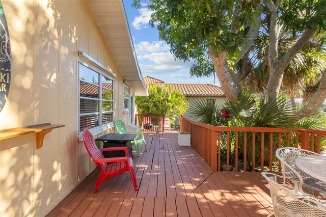 a view of balcony with wooden floor and outdoor seating