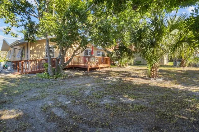 a view of outdoor space with deck and trees