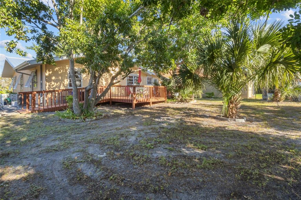 420 Pensacola Road Venice, FL 34285 - Photo 31 of 40 a view of outdoor space with deck and trees