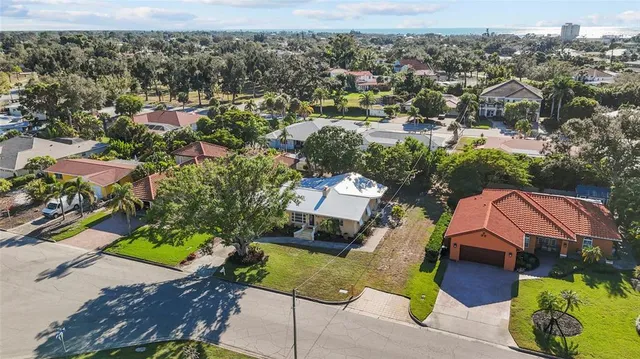 an aerial view of a house with a yard and lake view
