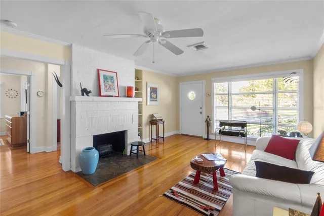 a living room with furniture fireplace and window