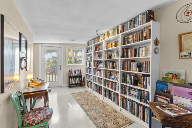 a living room with a book shelf and a book shelf