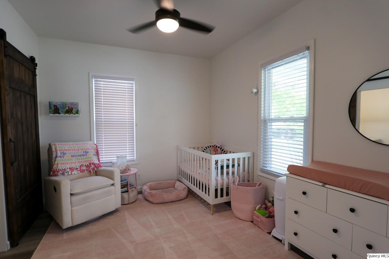 630 South 19th Street Quincy, IL 62301 - Photo 12 of 17 a bedroom with furniture and a window