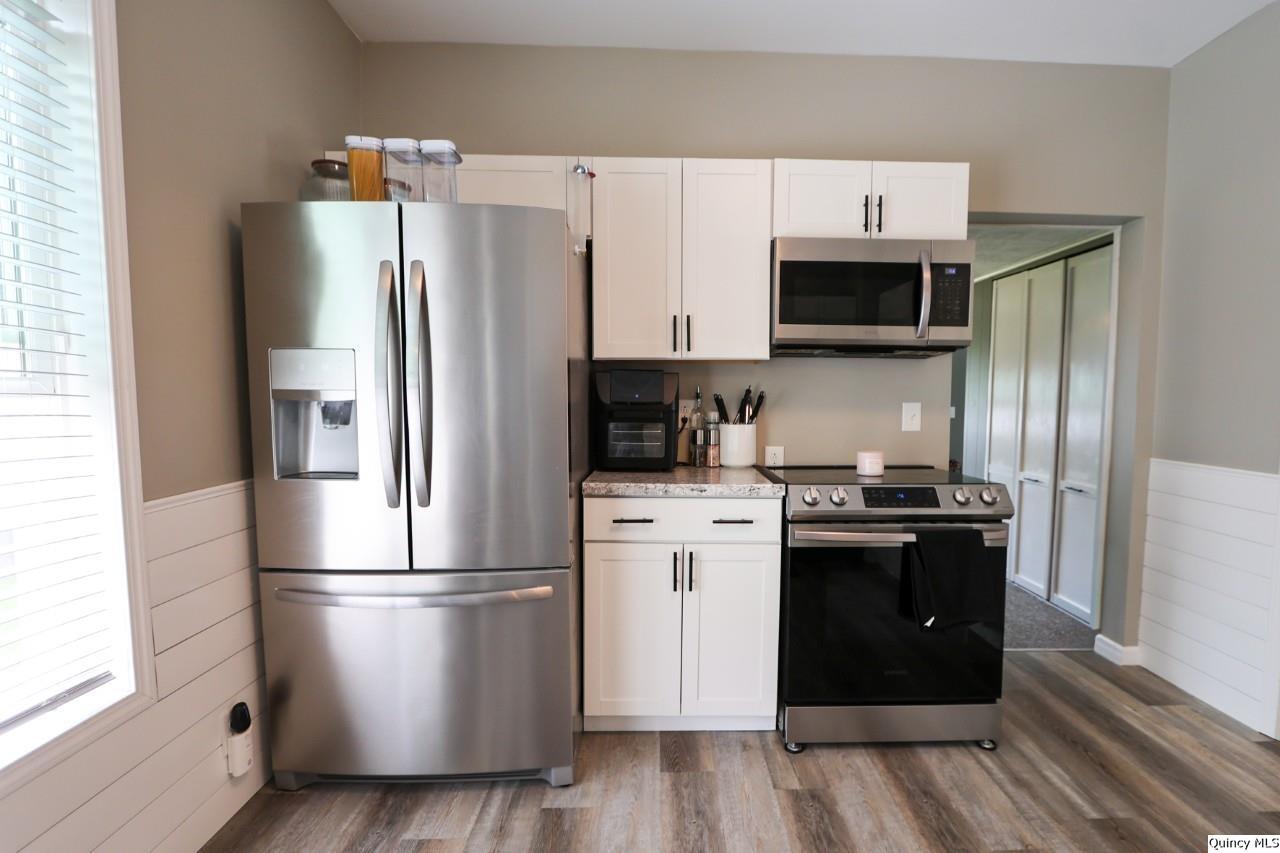 630 South 19th Street Quincy, IL 62301 - Photo 7 of 17 a kitchen with stainless steel appliances a refrigerator stove and microwave